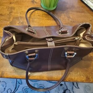 Tignanella brand Brown pebble grain leather.